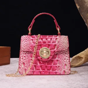 Close-up detail of retro fuchsia crocodile pattern handbag with gold hardware chain