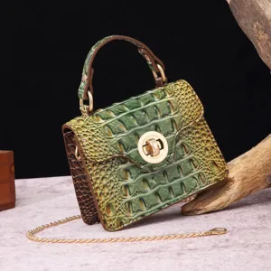 Close-up of vintage green embossed crocodile pattern handbag with gold hardware