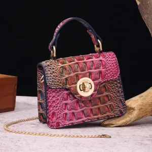 Detail view of a vintage multi-color crocodile embossed handbag with a gold chain strap