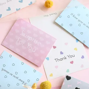 Detail view of minimalist greeting cards featuring heart patterns and sweet English messages