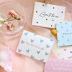 Close-up of minimalist heart-patterned thank you cards with inspirational English quotes