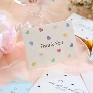 Detailed view of cream grid texture 'Thank You' greeting card with colorful hearts