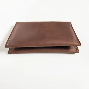 Side profile view of vintage brown crazy horse leather card holder with hand-stitched edges
