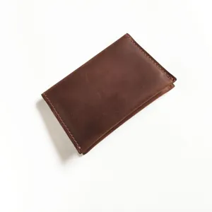 Detailed view of a vintage dark brown crazy horse leather card holder wallet with stitching