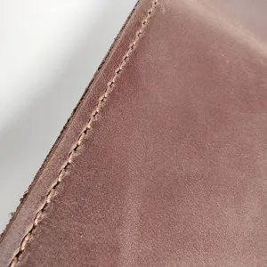Detailed close-up showing the texture of vintage brown Crazy Horse leather with stitching