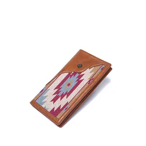 High-quality detail shot of a vintage Bohemian woven wallet in brown leather and canvas.