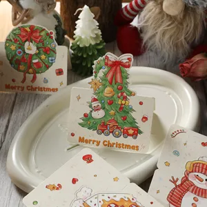 Detail von Vintage-Weihnachtsgrußkarten mit festlichen Baum- und Kranzmotiven