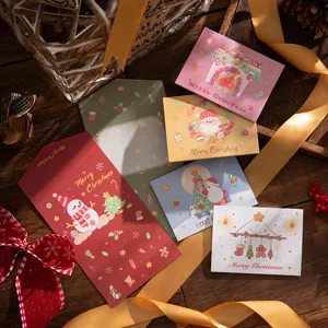 Set of assorted tri-fold Christmas greeting cards with festive snowman and Santa designs