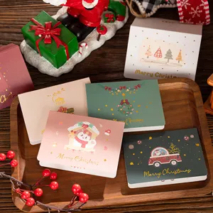 A detailed view of creative gold-stamped Christmas cards on a rustic wooden tray