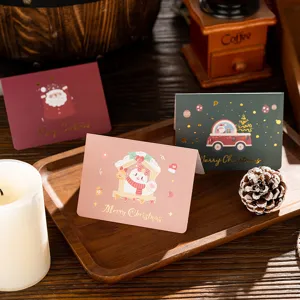 Detailed view of gold-stamped Christmas greeting cards with cute festive illustrations