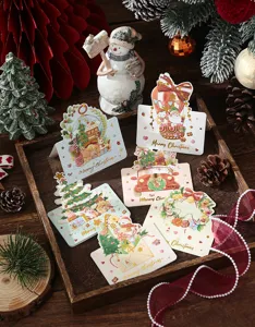 Assortment of Christmas greeting cards with gold foil patterns shown in a rustic setting.