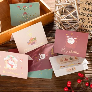 Close-up of elegant gold foil Christmas cards featuring festive holiday illustrations