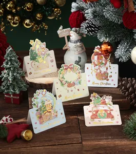 Detailed close-up of gold-stamped Christmas cards featuring festive holiday designs