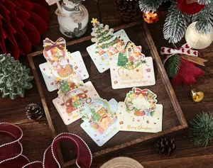 Detailed view of gold stamped Christmas message cards with festive holiday props
