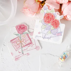 Close-up of hand-painted rose greeting cards for Valentine's Day with romantic quotes