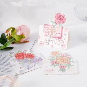 Detailed view of hand-painted rose greeting cards with elegant handwritten scripts.