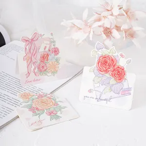 Close-up of hand-drawn rose greeting cards featuring elegant script and floral art