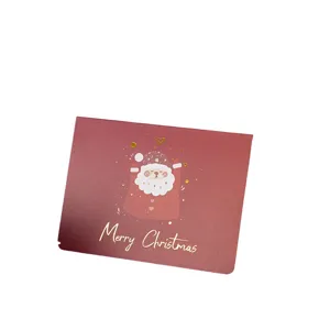 Festive red Christmas greeting card featuring a cute Santa and gold foil lettering