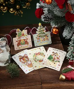 Detailed view of gold-stamped Christmas greeting cards in festive holiday setting.
