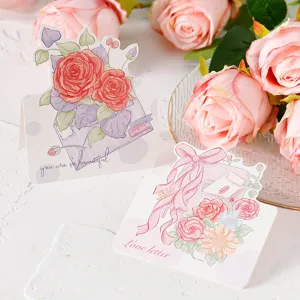 Detail view of hand-drawn floral greeting cards with Love letter and rose illustrations