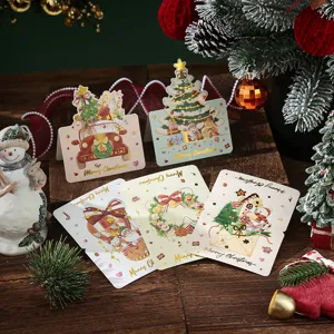 Elegant Christmas greeting cards with bronzing foil designs on a festive wood background.