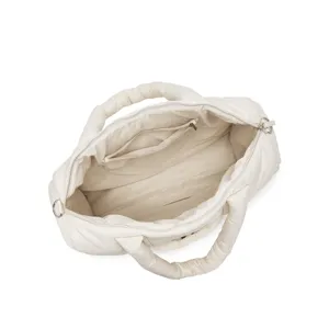 Gedetailleerd binnenaanzicht van een gewatteerde nylon draagtas met ruim vak en ritsvak