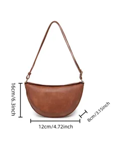 Detalle de bolso vintage marrón con medidas en pulgadas y centímetros