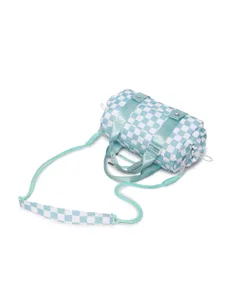 Detailed view of light blue checkerboard cylinder travel bag with adjustable strap