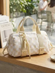 Large capacity beige and white checkerboard travel duffel bag displayed on a wooden surface