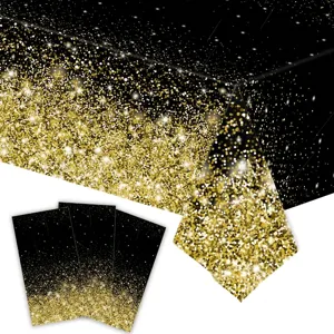Detailed view of a black and gold galaxy theme disposable PE tablecloth for birthday parties