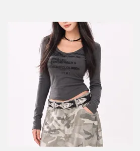 Close-up of Y2K style studded belt with ornate silver buckle on camo pants