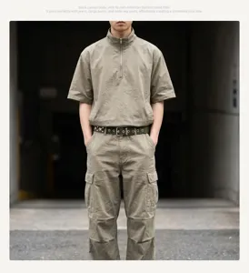 Full detail view of military green canvas belt with star studs on khaki cargo pants