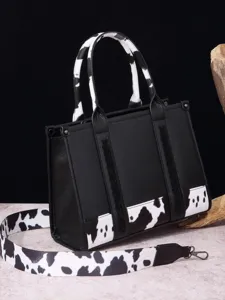 Bolso tote vintage estilo western negro con asas y correa ancha de estampado vaca