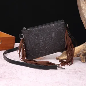 Detalle del bolso bandolera de cuero gofrado bohemio vintage con flecos largos.