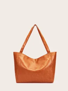 Vista frontal de un bolso tote vintage de cuero encerado marrón con gran capacidad y asas.
