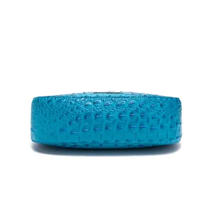 Vista macro dettagliata del motivo a coccodrillo blu su una borsa sottobraccio retrò
