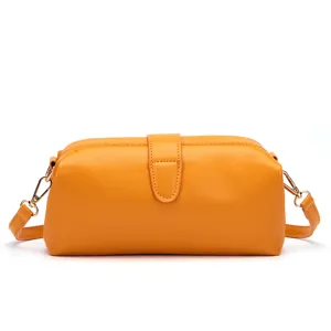 Detailed view of a vintage yellow mini crossbody doctor bag with clasp closure
