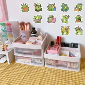 Detailed view of cute cartoon frog stickers displayed on a cozy organized desk setup