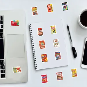 Creative American parody snack packaging stickers decorating a white notebook and laptop