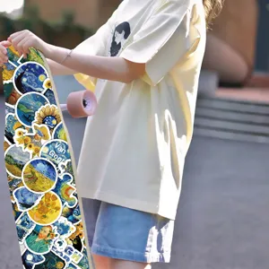 Detailed close-up view of artistic Van Gogh oil painting stickers on a cool skateboard.