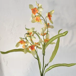 Close-up of realistic yellow and orange cymbidium artificial orchids for home decoration