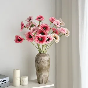 Elegantes amapolas artificiales flocadas en un jarrón rústico para el hogar