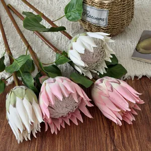 Close-up detail showing the realistic texture of pink and white artificial King Protea buds