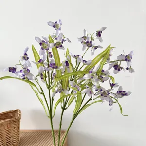 Close-up of elegant artificial white and purple Cymbidium flowers for home decor