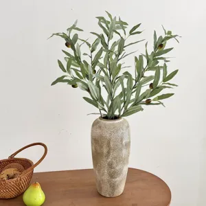 Realistic artificial olive branches with fruits arranged in a rustic ceramic vase.