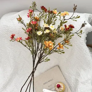 Close-up detail of vintage autumn artificial daisy bouquet on textured white background