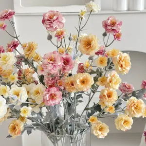 Close-up of artificial camellia bouquet with flocked stems in a glass vase