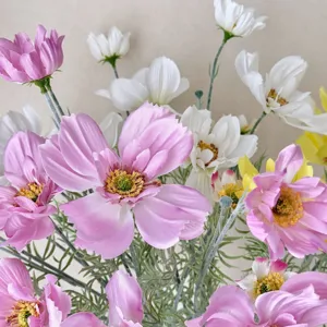 Detailed close-up of pink and white silk cosmos artificial flowers for decoration