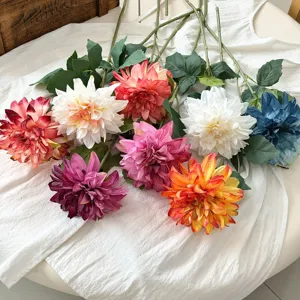 Detailed view of colorful retro burnt edge dahlia artificial flowers on white cloth