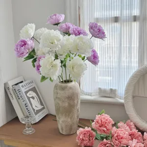 Close-up of elegant 3-head artificial silk peonies in pink and white for home decor
